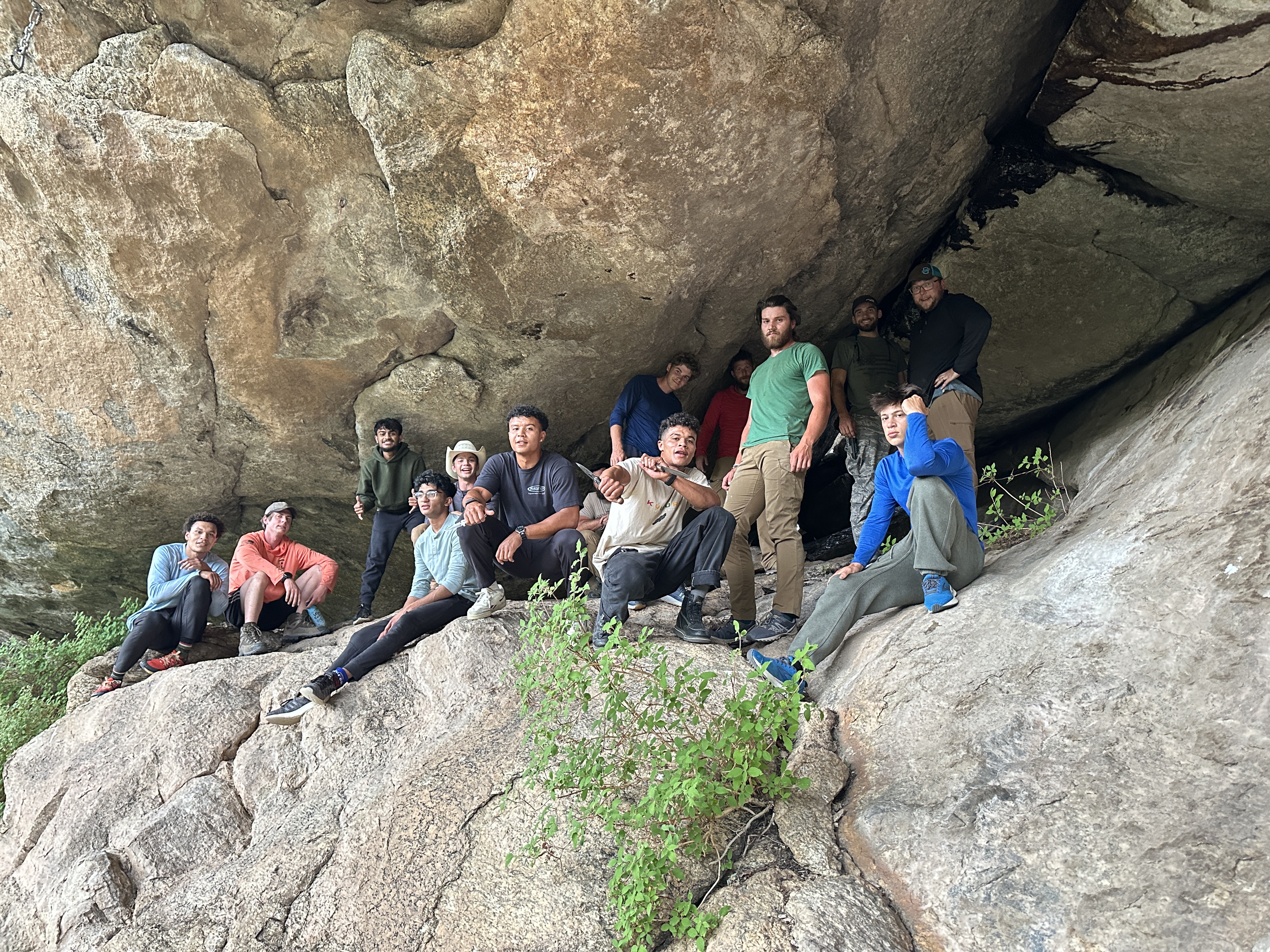 Abide Project group photo in a rock alcove during a wilderness expedition